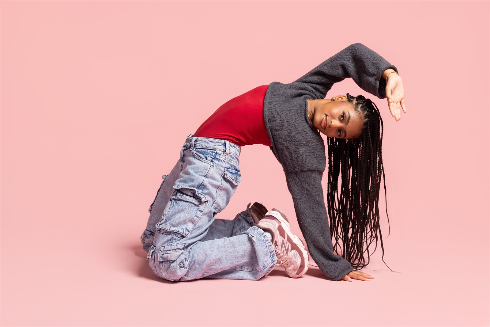 Heaven King in a dynamic dance pose on a pink background